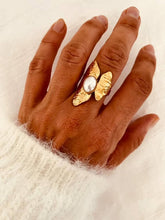 Load image into Gallery viewer, AFON freshwater pearl statement ring worn on the hand, showcasing the organic gold-plated textured design surrounding a genuine freshwater pearl.