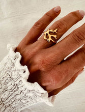 Load image into Gallery viewer, Abstract coral ring in gold plated stainless steel shown on hand highlighting modern minimalist statement jewelry design