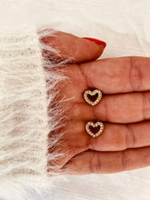 Učitaj sliku u preglednik galerije, Crystal heart stud earrings in 18K gold plated stainless steel shown from front angle highlighting sparkling stones and cute minimalist design