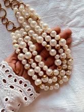 Load image into Gallery viewer, Close-up of the EMMELINA necklace highlighting luxurious layered artificial pearls and polished gold details.