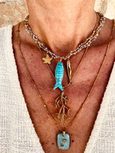 Load image into Gallery viewer, Elegant gold coral pendant necklace layered with a sculptural fish necklace for a sophisticated summer look.
