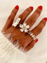 Load image into Gallery viewer, PAISA statement ring worn on the hand featuring a large emerald cut crystal set on an elegant gold adjustable band.