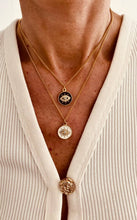 Load image into Gallery viewer, Stainless steel evil eye necklace styled with casual outfit showing versatility as everyday luxury jewelry piece