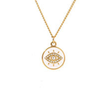 Load image into Gallery viewer, Flat lay of white evil eye necklace with cubic zirconia pendant styled on neutral background highlighting modern luxury jewelry branding
