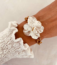 Load image into Gallery viewer, Close-up of pearl flower detail on gold chain bracelet worn on wrist