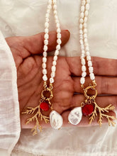 Load image into Gallery viewer, Handmade natural pearl necklace with gold ocean inspired charms styled on neckline for elegant summer jewelry look