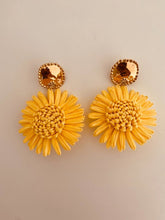 Load image into Gallery viewer, NAYA handcrafted yellow flower earrings displayed on a white background, featuring woven raffia petals with elegant gold-plated stud tops.