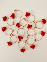 Load image into Gallery viewer, Side angle of geometric circle and heart earrings showing dimensional structure and modern design