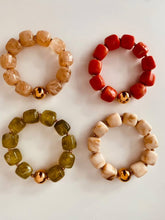 Load image into Gallery viewer, IZZA bracelet colour collection showcasing four glossy marbled resin designs with polished gold centre beads.