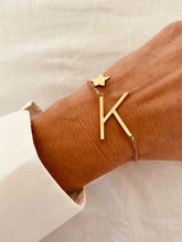 Load image into Gallery viewer, Close-up of gold initial bracelet with small star charm showcasing elegant minimalist design