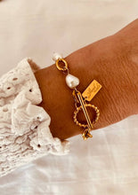 Load image into Gallery viewer, Close-up of gold pearl bracelet on wrist showcasing natural pearls and refined chain detail