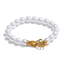 Load image into Gallery viewer, Pearl bracelet with gold stainless steel buckle and zircon detail shown from front angle highlighting minimalist elegant jewelry design