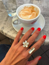 Load image into Gallery viewer, Gold emerald cut crystal ring styled next to a crystal flower ring creating an elegant luxury jewelry combination.
