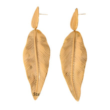Load image into Gallery viewer, These striking dangle earrings feature a large, gold-plated stainless steel leaf hanging gracefully from a smaller, matching leaf, each adorned with intricate notches for added texture and dimension. The bold design makes these earrings a true statement piece, perfect for adding elegance to party outfits or enhancing everyday style with a touch of nature-inspired beauty.