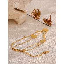 Load image into Gallery viewer, Add a touch of summer romance to your style with this exquisitely crafted gold anklet. Made from high-quality, gold-plated stainless steel, it features a delicate double-chain design. One chain is adorned with dainty gold beads, while the other is beautifully decorated with charming white flowers, creating a perfect balance of elegance and whimsy. With its secure lobster clasp and adjustable length, this anklet is the ideal accessory to enhance your summer look, adding a subtle yet sophisticated touch to yo
