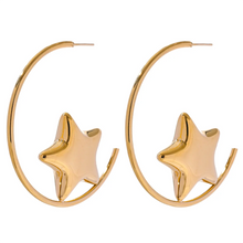 Load image into Gallery viewer, Enhance your style with these trendy stainless steel round star huggie earrings, available in sleek silver and radiant gold. Designed for modern women, their minimalist star charm adds a touch of elegance to any look. Crafted from anti-allergic stainless steel, they ensure comfort and durability, making them perfect for everyday wear. Whether as a thoughtful gift or a chic addition to your jewelry collection, these versatile earrings blend fashion and sophistication effortlessly.