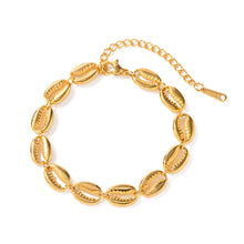 Load image into Gallery viewer, Gold shell bracelet displayed on neutral background showcasing clean modern jewelry aesthetic