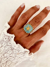 Load image into Gallery viewer, Gold plated stainless steel ring featuring a turquoise centre and raised starfish detail