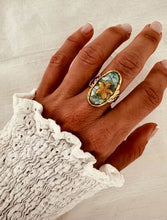 Load image into Gallery viewer, Turquoise starfish statement ring in gold plated stainless steel shown on hand highlighting ocean inspired jewelry design