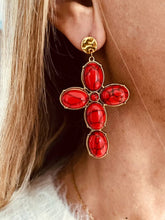 Load image into Gallery viewer, VLAHA red cross statement earrings worn on the ear featuring marbled red resin stones set in vintage-inspired gold frames.
