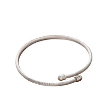 Load image into Gallery viewer, Vintage open bangle bracelet in gold and silver stainless steel shown from front angle highlighting minimalist elegant jewelry design