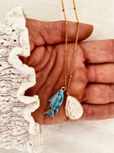 Load image into Gallery viewer, Anderson coastal necklace featuring a freshwater pearl pendant and blue fish charm on a delicate gold-plated chain