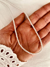 Load image into Gallery viewer, Beaded pearl necklace with imitation pearls and stainless steel chain displayed from the front showing classic and elegant design