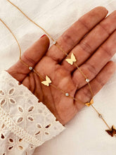 Load image into Gallery viewer, Necklace held in hand showing size of butterfly charms and dangling chain detail