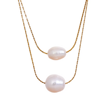 Load image into Gallery viewer, Close up of natural freshwater pearls on stainless steel layered necklace highlighting smooth surface shine and organic texture