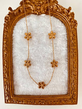 Load image into Gallery viewer, Necklace styled on bright summer themed background enhancing warm tones and seasonal aesthetic
