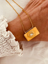 Load image into Gallery viewer, Gold sun pendant necklace with rectangular shape and radiant sun design front view