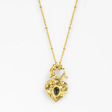 Load image into Gallery viewer, Close up of heart pendant with black stone on gold plated necklace