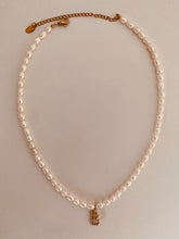 Load image into Gallery viewer, Close-up of natural pearl necklace with gold letter pendant