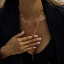Load image into Gallery viewer, Model wearing 18K gold plated Y-shaped pearl necklace styled for layering and special occasions.