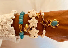 Load image into Gallery viewer, Gold and white coastal bracelet worn on wrist in summer styling