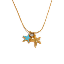 Load image into Gallery viewer, Close up of small pendants showing gold and turquoise starfish charms alongside a sparkling cubic zirconia stone