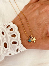 Load image into Gallery viewer, Gold stainless steel starfish charm necklace with turquoise detail and cubic zirconia pendant displayed on a fine chain for a playful summer look