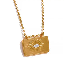 Load image into Gallery viewer, Close up of sunburst pendant necklace with cubic zirconia centre and carved rays