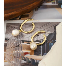 Load image into Gallery viewer, Elegant metal earrings are made in a gold colour. They consists of a big irregular hoop on which a natural pearl is attached. Earrings has real gold plating and represent perfect and elegant touch to your classy and elegant outfit. They have stud fastening.