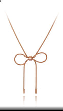 Load image into Gallery viewer, Stainless steel necklace comes in a rose gold colour. It is made of fine thin snake chain which ends with a big bowknot. The necklace is very simple, though makes a perfect accessorize to your outfit. It has lobster clasp.