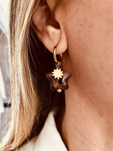 Load image into Gallery viewer, Leopard print star drop earrings styled with outfit emphasizing bold fashion statement and trendy accessory appeal
