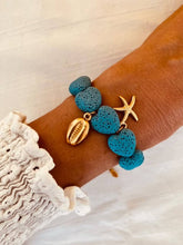 Load image into Gallery viewer, ALICE bracelet featuring turquoise lava stone heart beads with gold starfish and shell charms.
