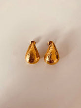 Load image into Gallery viewer, ANA gold teardrop stud earrings worn on the ear, highlighting their sculptural textured finish and elegant everyday design.
