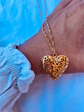 Load image into Gallery viewer, Gold filigree heart necklace that opens to hold a small photograph.
