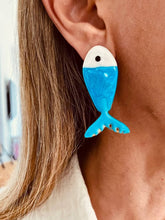 Load image into Gallery viewer, Blue FISHOLINA fish earrings worn on the ear.
