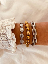 Load image into Gallery viewer, Stainless steel chain bracelet layered with other jewelry creating modern stacked look

