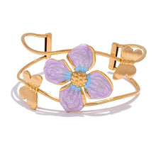 Load image into Gallery viewer, Gold plated stainless steel bangle with butterfly and purple flower enamel shown on wrist highlighting bold statement jewelry design
