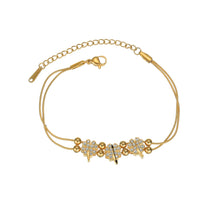 Load image into Gallery viewer, Clover zircon bracelet in gold plated stainless steel shown from front angle highlighting elegant lucky charm jewelry design
