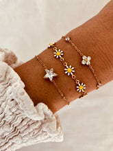 Load image into Gallery viewer, Daisy enamel bracelet layered with other jewelry showing trendy stacking style
