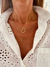 Load image into Gallery viewer, Gold plated stainless steel custom two letter necklace shown on neckline highlighting personalized jewelry design
